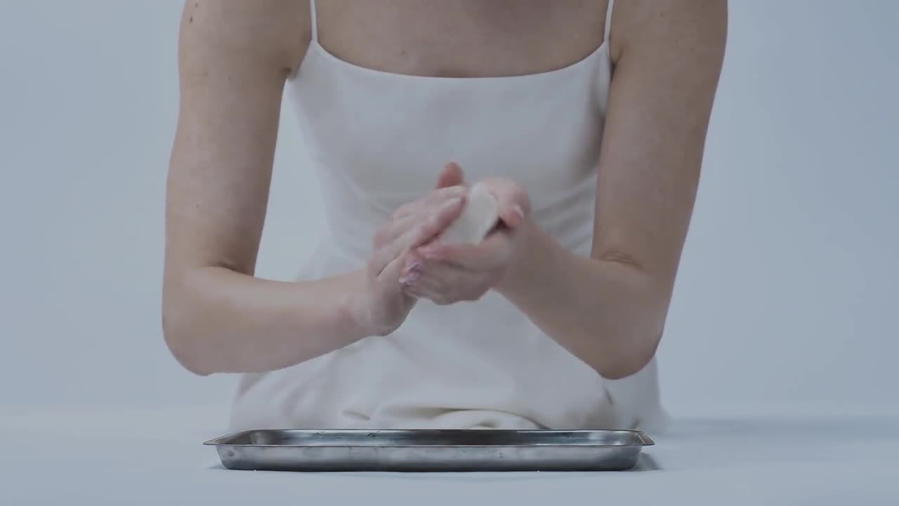 LUMA campaign film: model shaping a bar of soap above a steel tray